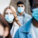 A group of people wearing masks Description automatically generated with medium confidence